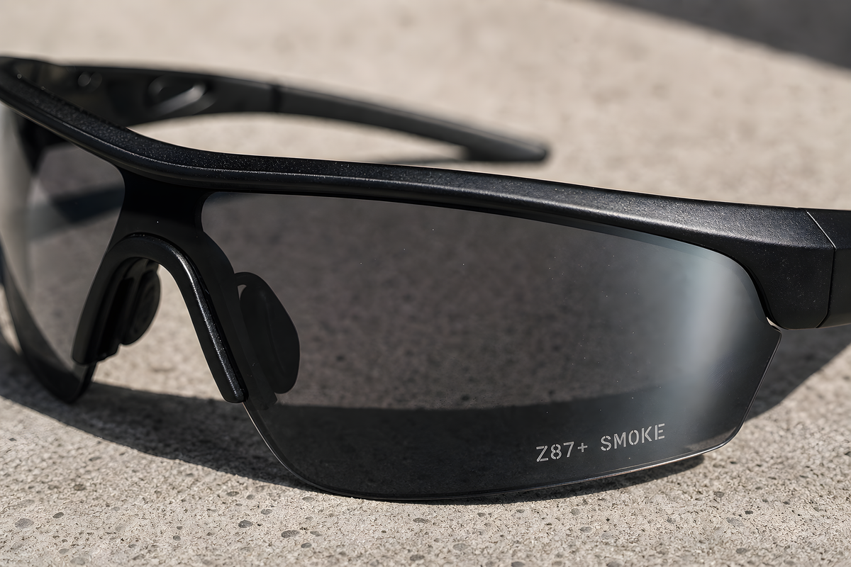 GRAFT the device macro: the Z87+ SMOKE stencil etched at the lens edge, the coating's color shift catching light